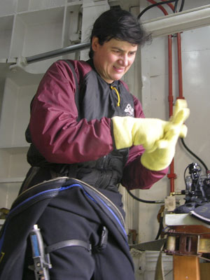 It is more difficult to pull the second pair of yellow knit gloves over the first fleece ones.