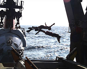 BLee Williams and Mark Drewery perform swan dives off Alvin as it is hoisted up for recovery. 