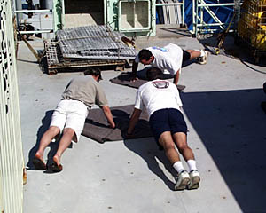 Captain Tim McGee (background), Dan Stuermer (right) and Paul Oberlander do a 40 minute Navy SEAL excercise drill. 