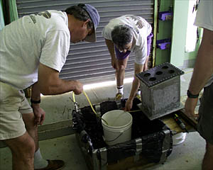 Dan Stuermer (left), Dan Fornari (center), and Del work to replace one of the camera sled batteries that flooded during last night’s tow. The battery must be replaced so that the scheduled tow can continue tonight.