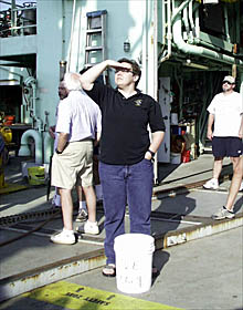 Margo, a.k.a. “The Prankster”, awaits the return of Del with a bucket of ice water. 