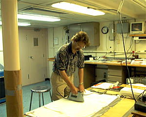 Paul Oberlander irons his cruise logo design onto 54 T-shirts for everyone on the ship.
