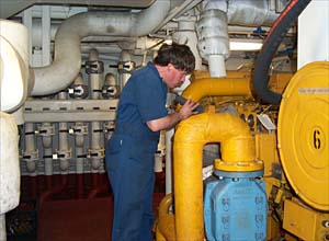Kevin Fisk, the Chief Engineer, makes his rounds in the engine room. 