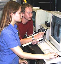 Kate Gans and Peter Lean discuss how to interpret a seafloor volcanic feature that they are seeing on the sonar monitor in the Control Van.