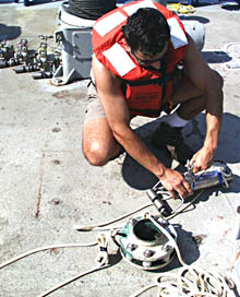 Rob Palomares, Scripps’ CTD technician, unbolts a MAPR (Miniature Autonomous Plume Recorder) from a line connected to our DSL-120 sonar fish. As the “fish” surveyed the seafloor over the last three days, the MAPR collected data about seawater properties (temperature, conductivity, and how clear the water was) about 75 meters above the ocean bottom. We are now downloading data from the MAPR and will analyze it during the next few days.