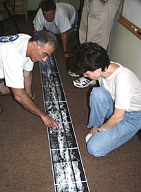 Today in the library on board R/V Melville, Mike Perfit (left), Maya Tolstoy (right), Ben Wigham (center) and some other students studied the sonar records that we collected last night with the DSL-120 sonar. They were deciding how to plan the rest of the sonar surveys and where to take the first rock dredge samples tomorrow night. The rolled-out sonar strip spans about 20 nautical miles (nearly 40 kilometers) of the East Pacific Rise crest and covers a swath about 1 kilometer wide.