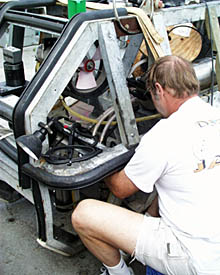 Meanwhile, at the front end of Argo, Bob “Yogi” Elder, the team leader for the WHOI Deep Submergence Operations Group, is adjusting the position of a video camera. Do you see the propeller inside the Argo frame, just to the left of Yogi’s head? This is part of a thruster that is used to move Argo from side-to-side as it is being towed just 10 meters above the seafloor.