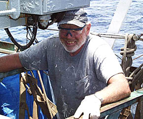 Bill Kamholtz, Melville’s Bosun, chips rust off the power control panel for the aft crane on R/V Melville. Cranes are a critical piece of shipboard equipment needed to lift and move heavy pieces of equipment around the deck, and to load and unload the ship when it is in port. Notice that Bill is wearing safety glasses to protect his eyes as chips of rust can fly everywhere.