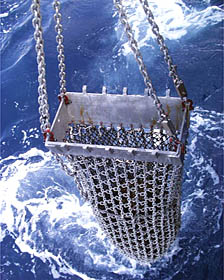 The dredge comes on board R/V Melville. We have dragged it over the lava flows on the East Pacific Rise crest eight times in the past few days to collect rocks. This dredge was actually “hung-up” or stuck on the seafloor for about an hour. We suspect that it got wedged into one of the cracks or fissures that we saw in the Argo II video. Thankfully, we were able to get it unstuck!