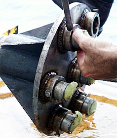 A close-up of the “business end” of the rock corer. Notice all the small chips of black, volcanic glass that are stuck in the pale yellow surfboard wax. The wax will be melted in the shipboard laboratory to get the glass samples out.
