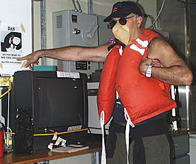 Mike Perfit impersonating “Feathers” and pointing to one of the posters put up by the Pollywogs.