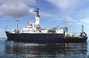 R/V Melville floats sedately in the glassy seas of the Pacific Ocean near 1° 40’N latitude and 102° 17’W longitude. You can almost see a perfect reflection of the ship in the water!
