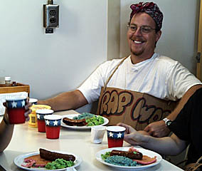 A special “Dr. Suess” breakfast for the Pollywogs this morning -- green eggs and ham, blue oatmeal, and large sausages. Mmmmm! How appetizing! The sign around Erin Todd’s neck is the “Pollywog name” assigned to him by the Shellbacks. Erin’s name is “Rap” because rap is his favorite kind of music. Each Pollywog receives his or her own special name that reflects humorous elements of the personalities or habits of each person.