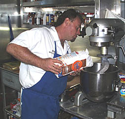 Dan Engelbrecht pours flour into the industrial mixer to make fresh bread. Making fresh baked goods on board is one of the trademarks of a great shipboard cook. Dan and George tempt the scientists and crew each day by making a selection of rolls, breads, pizza, cakes, muffins, and cookies.