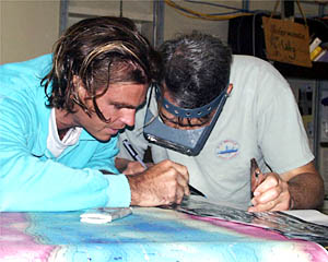 Greg Kurras (left) and Dan Fornari study details in the DSL-120 data. Dan is wearing magnifying glasses that Bob “Yogi” Elder loaned him so he can see the small scale details in the DSL-120 sonar records. 