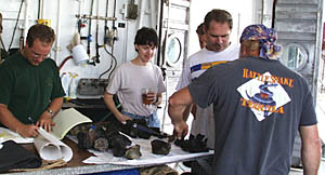 Everyone is interested in rocks, particularly when they are very fresh! Erin Todd (left) describes and records the samples, while Maya Tolstoy, Dave Murline, and Ron Comer (back to camera) check out the fresh, glassy lavas.