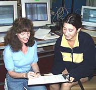 Rachel and Clare Williams discuss log keeping while on watch in the Main Lab.