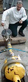 Mike getting ready to launch the rock corer on a recent cruise to the Juan de Fuca Ridge. The corer gets bashed into the seafloor lava flows and chips off pieces of volcanic glass. The glass gets embedded in steel cups that are filled with surfboard wax on the nose of the corer. Mike analyzes the glass chips back in his lab. to determine the chemistry of the lava.