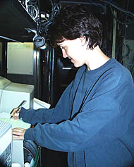 Maya keeps careful records during her watch in the Control Van.