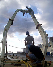 Seaman Bill Dunn prepares a line that will be used to hang the block from the A-frame on Knorr’s fantail. The block is like a large pulley that helps to guide the heavy fiber optic cable over the stern of the ship.