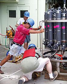  Bosun Alan Hopkins, Seaman Kevin Butler and oceanographer Bob Collier work together to make a final adjustment to sensors on the CTD before its test lowering.  
