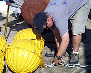 DSOG team member Paul Johnson rigs floats for the current meter. Scientists use the current meter to measure the speed and direction of ocean currents. 