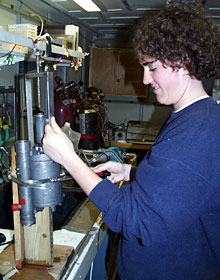 Graduate student Rachel Gallant extracts a sample of hydrothermal fluid from a titanium water sampling bottle. For a short time, her lab filled with the smell of rotten eggs because of the hydrogen sulfide in the sample.