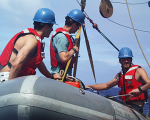 Fran Taylor, Adam Seamans and Kent Sheasley are lifted back on to Knorr in the workboat after retrieving the elevator when it came to the surface.  