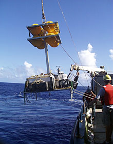 Knorr’s starboard crane lifts the elevator over the side yesterday when the weather was calm.  