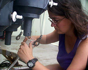 After the CTD arrives on deck, SSSG technician Amy Simoneau helps draw water samples from the collection bottles. The SSSG technicians, or Shipboard Scientific Services Group techs, have to know about many different types of oceanographic equipment to help the range of scientists that come on board Knorr to do their work.