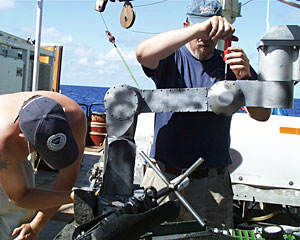  Chief Jason pilot Will Sellers and DSOG team member Pete Collins make adjustments on ROV Jason’s manipulator arm.  