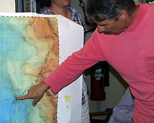 At a science meeting today, Geologist Dan Fornari points to the area where the Plume Team detected a strong hydrothermal signal near 24°S.  