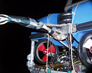 The back of ROV Jason shows the newly created fiber optic tether made by the DSOG Team this afternoon. When Jason was recovered early this morning, the tether separated from the vehicle.  