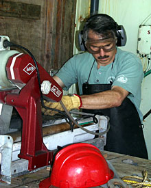 Geologist Dan Fornari cuts volcanic rocks using a special water-cooled, diamond-edged saw blade. The goggles and apron protect his body from flying rock chips and spray.  