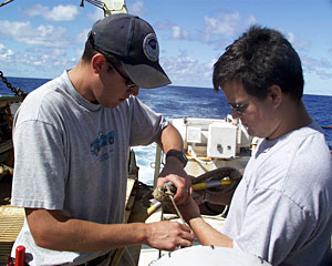DSOG team members Pete Collins (left) and Mark Bokenfohr work on ROV Jason’s tether this morning before sending the vehicle back to the Edmond field for sampling. 