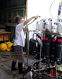 Chemist Chi Meredith gives the CTD a fresh water spray after its final plunge into the ocean this morning.  