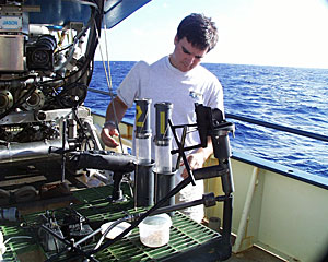 DSOG team member Mark Bokenfohr adjusts push cores on ROV Jason’s basket for today’s final sampling at the Edmond Vent Field.  