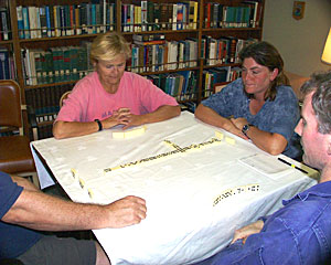Playing dominoes, watching movies and reading are popular evening activities. Here Shana Goffredi and Dave Sims (out of the picture) challenge Janet Costello and Steve Walsh to a game.  