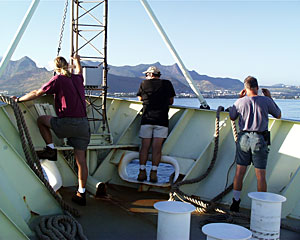 Chief Mate Kent Sheasley, Seaman Jim McGill and Bosun Al Hopkins look ahead to Mauritius as we pull into port at the end of our month-long expedition in the Indian Ocean.  