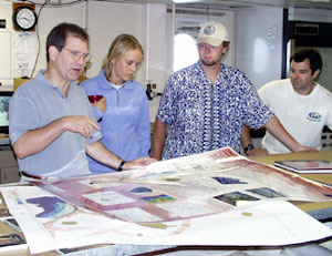 Mark Kurz leads the morning's science meeting as Jenny Engels, Jeremy Haney, and Josh Curtice look on. Today's discussion focused on the geological features near Fernandina and Isabela Islands. 