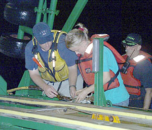 Paul Johnson and Jenny Engels of the Hawaii MR1 Group make final preparations for launching the MR1 sonar fish this evening. 