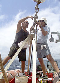  Victor Barnhart, the Bosun, and Lorna Allison, an Ordinary Seaman, check that the lifeboat is properly secured and that it's in working order.  