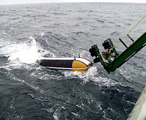   This morning the MR1 sonar fish was recovered. About 500 meters of cable is reeled in to get the fish close to the ship and then a specially made cradle with a hydraulic lift is used to pull it out of the water.