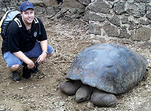 Paul Johnson with a giant Galápagos tortoise at the Darwin Research Station on Santa Cruz. The Galápagos is one of only two places in the world that have giant tortoises, the other being the Seychelles in the Indian Ocean. There were originally 14 subspecies in the Galápagos, but only 11 survive today, mainly because of their destruction by humans.