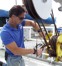 Able Seaman James Pearson makes repairs to a winch, using the wire loops he made yesterday. 