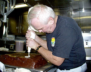 Ed Miller, Senior Cook, makes early preparations for the birthday boys on board.