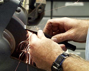 Steve St. Martin, 2nd Assistant Engineer, grinds a chisel that the scientists use to break rocks. The crew must be able to repair tools and equipment on board, because we are far away from the nearest repair shop or hardware store.