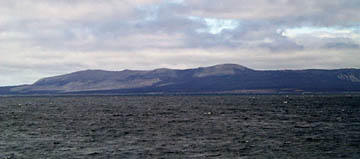 The north flank of Marchena Island as we sailed by during our sonar surveying this morning. The dark areas on the island are recent a’a lava flows.  