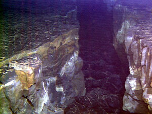 Photo of an underwater fissure taken during an Alvin dive on the East Pacific Rise. The darker lava at the bottom of the fissure is a new eruption. We believe this same type of process occurs here on the submarine rift zones of Fernandina and Cerro Azul volcanoes.