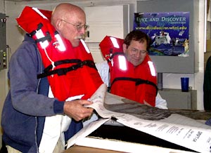 Gene Pillard and Mark Kurz are always working hard. Here they plan dredge positions while waiting for the fire and boat drills to commence. 